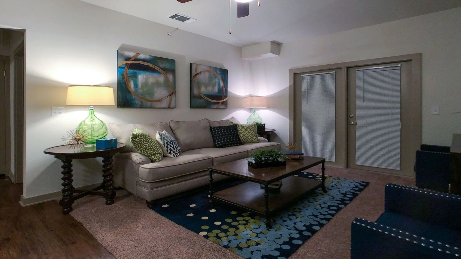 a living room with a couch, coffee table and lamp at The Anatole on MacArthur North