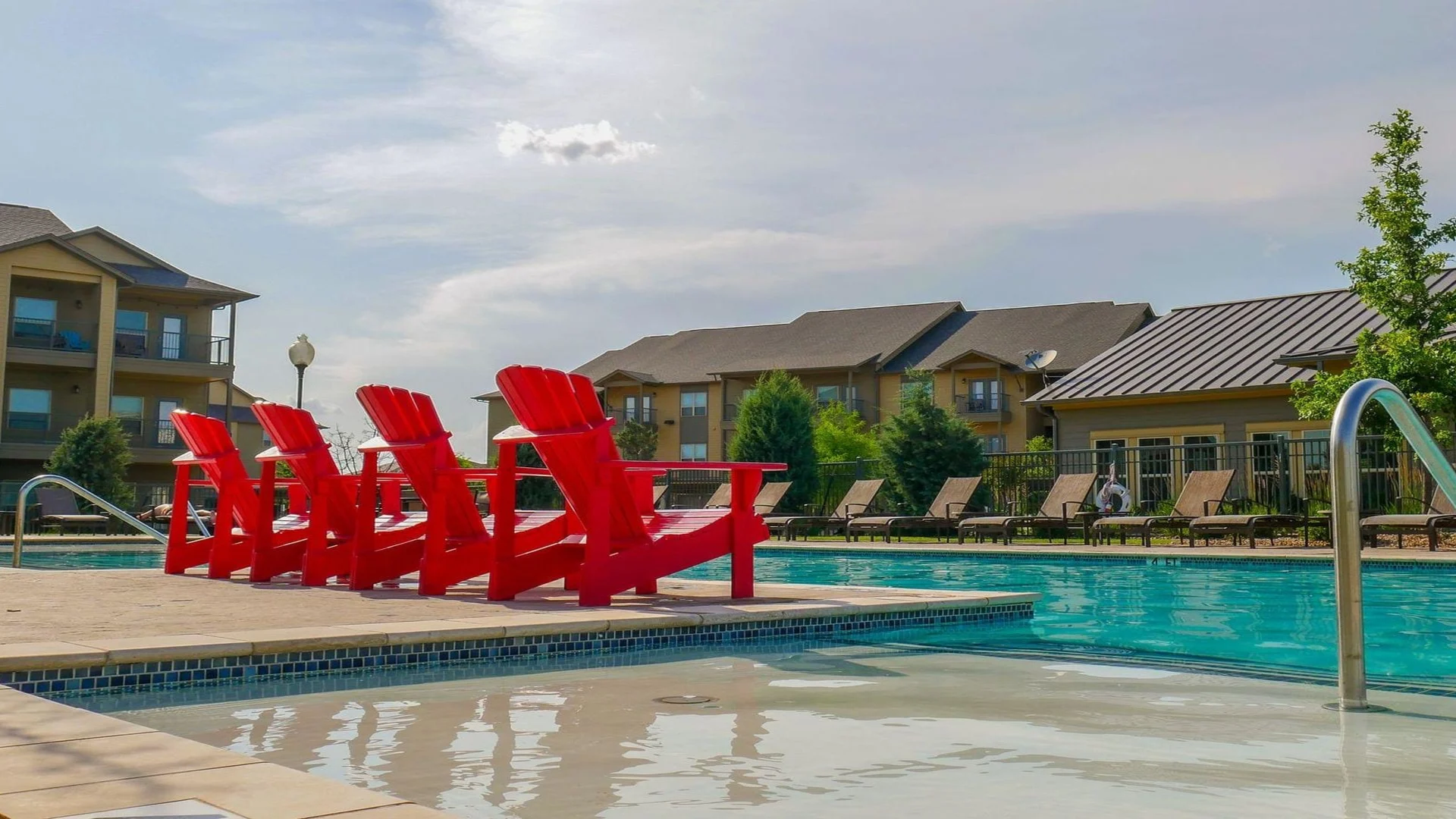 red chairs by the pool at a resort at The Anatole on MacArthur North