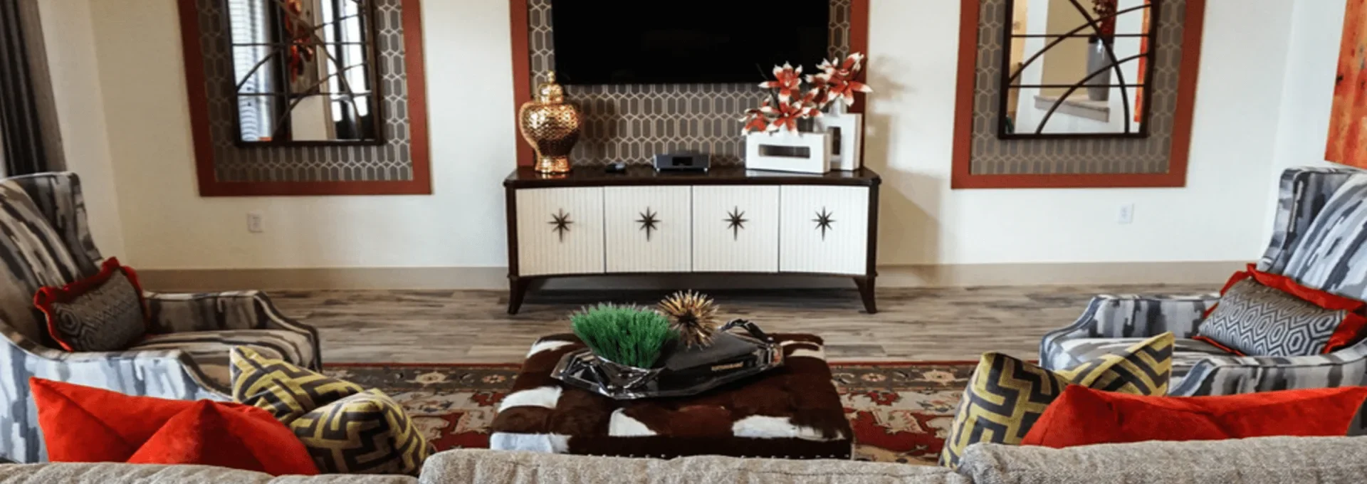 a living room with a large flat screen tv and a couch at The Anatole on MacArthur North